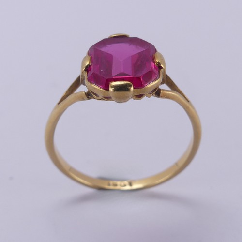 150 - A single stone pink sapphire Ring, the rectangular stone with canted corners, in four claw 18ct gold... 