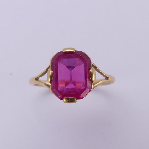 150 - A single stone pink sapphire Ring, the rectangular stone with canted corners, in four claw 18ct gold... 