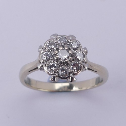 156 - A diamond cluster Ring, the central circular diamond with eight stones around, all claw set in 18ct ... 