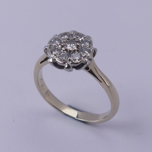 156 - A diamond cluster Ring, the central circular diamond with eight stones around, all claw set in 18ct ... 