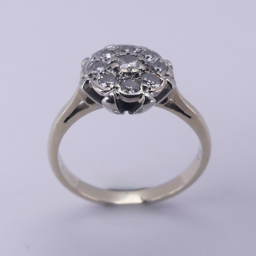 156 - A diamond cluster Ring, the central circular diamond with eight stones around, all claw set in 18ct ... 