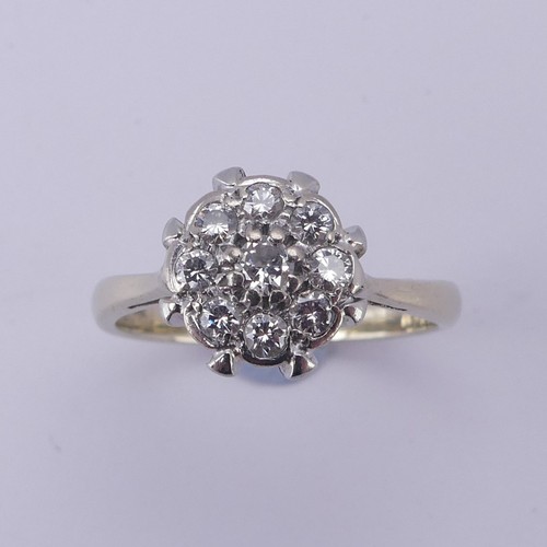 156 - A diamond cluster Ring, the central circular diamond with eight stones around, all claw set in 18ct ... 