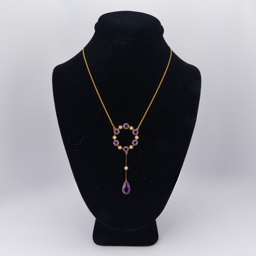 201 - An Edwardian amethyst and seed pearl Pendant, the open circular pendant with knife wire drop below s... 