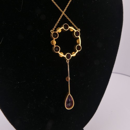 201 - An Edwardian amethyst and seed pearl Pendant, the open circular pendant with knife wire drop below s... 