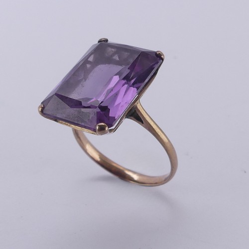 159 - A synthetic color change sapphire Ring, the emerald cut stone approx. 17.8mm long, mounted in unmark... 