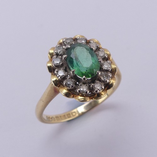 161 - A demantoid garnet and diamond cluster Ring, the oval facetted garnet, approx. 6.8mm long, surrounde... 