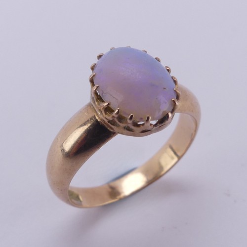 162 - An oval opal Ring, the stone approx. 10mm long, claw set in 15ct gold, Size L, 4.2g.... 