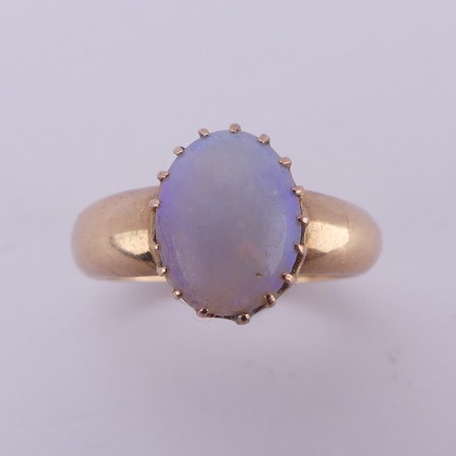 162 - An oval opal Ring, the stone approx. 10mm long, claw set in 15ct gold, Size L, 4.2g.... 