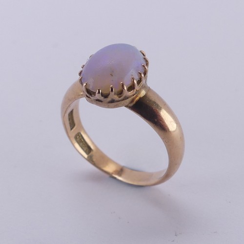 162 - An oval opal Ring, the stone approx. 10mm long, claw set in 15ct gold, Size L, 4.2g.... 