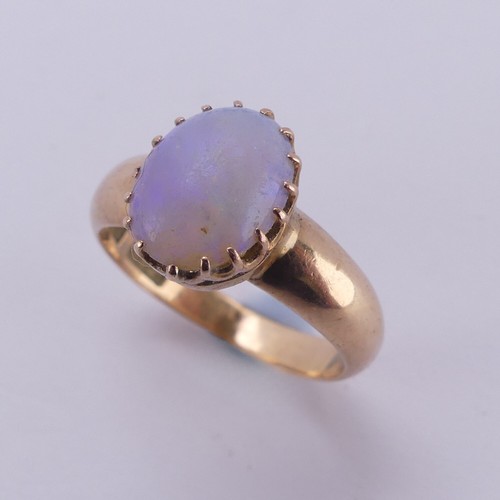 162 - An oval opal Ring, the stone approx. 10mm long, claw set in 15ct gold, Size L, 4.2g.... 