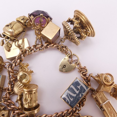 215 - A 9ct rose gold curb link Bracelet, with 9ct gold padlock clasp, suspended with 22 various 9ct gold ... 