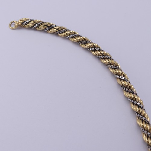 216 - An 18ct yellow and white gold ropetwist Bracelet, with small bolt ring clasp, 21cm long, 21.2g.... 