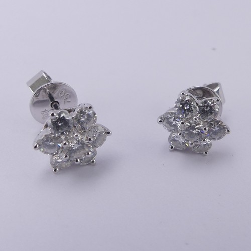 233 - A pair of diamond cluster Earrings, the central brilliant cut stone approx. 0.12ct claw set above si... 