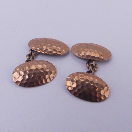 267 - A pair of 9ct rose gold oval Cufflinks, with hammered decoration, 4.3g.