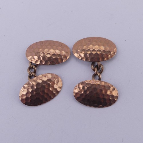 267 - A pair of 9ct rose gold oval Cufflinks, with hammered decoration, 4.3g.