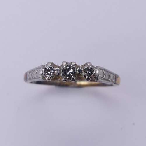 169 - A small three stone diamond Ring, mounted in 18ct yellow gold and platinum, Size O, 2.5g.... 