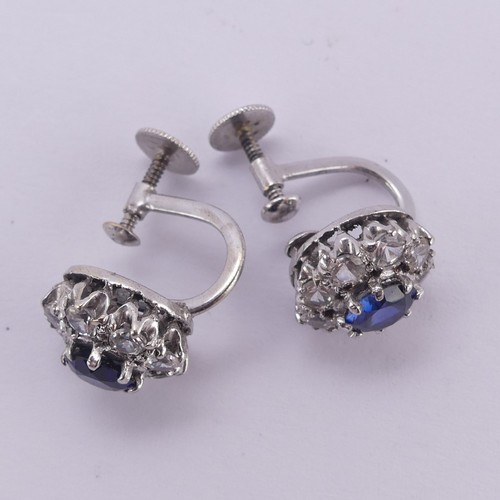 234 - A pair of synthetic sapphire cluster Earrings, the circular facetted stones claw set above a surroun... 