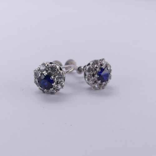 234 - A pair of synthetic sapphire cluster Earrings, the circular facetted stones claw set above a surroun... 