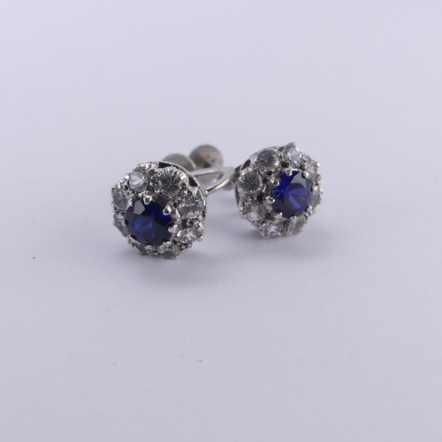 234 - A pair of synthetic sapphire cluster Earrings, the circular facetted stones claw set above a surroun... 