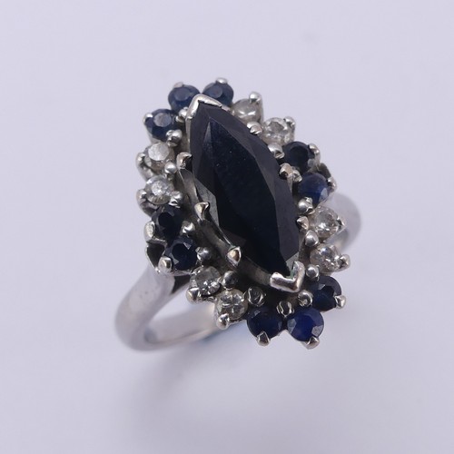 176 - A Sapphire and diamond cluster Dress Ring, the navette shaped facetted central sapphire approx. 12.9... 