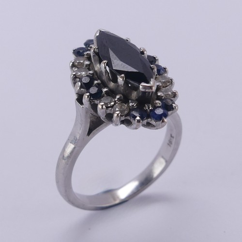 176 - A Sapphire and diamond cluster Dress Ring, the navette shaped facetted central sapphire approx. 12.9... 