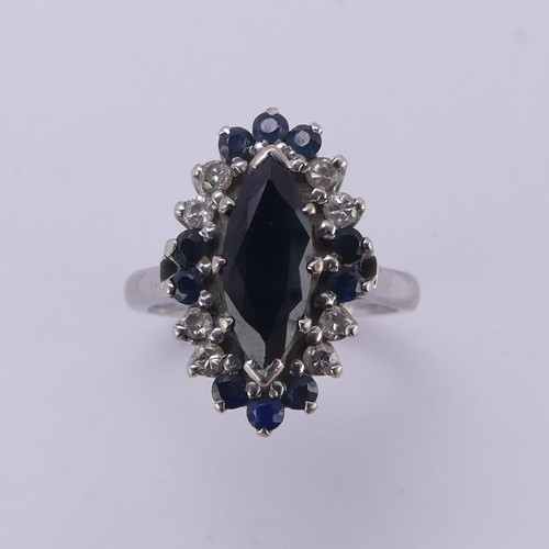 176 - A Sapphire and diamond cluster Dress Ring, the navette shaped facetted central sapphire approx. 12.9... 