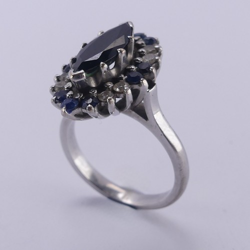 176 - A Sapphire and diamond cluster Dress Ring, the navette shaped facetted central sapphire approx. 12.9... 