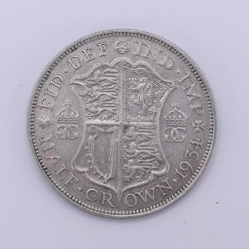 325 - A George IV Half Crown, dated 1825, better grade, together with two George V florins, dated 1916 and... 