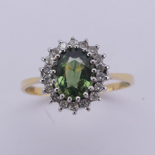 177 - A green sapphire and diamond cluster Ring, the oval facetted central stone approx. 8mm long, surroun... 