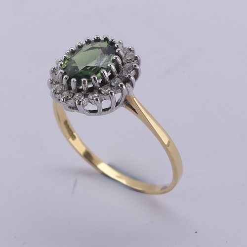 177 - A green sapphire and diamond cluster Ring, the oval facetted central stone approx. 8mm long, surroun... 