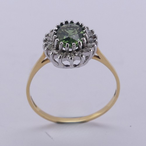 177 - A green sapphire and diamond cluster Ring, the oval facetted central stone approx. 8mm long, surroun... 