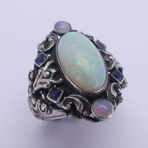 138 - An Arts and Crafts silver Ring, in the manner of Bernard Instone, with central cabochon opal, approx... 