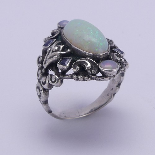 138 - An Arts and Crafts silver Ring, in the manner of Bernard Instone, with central cabochon opal, approx... 