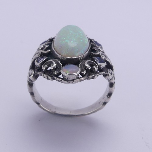 138 - An Arts and Crafts silver Ring, in the manner of Bernard Instone, with central cabochon opal, approx... 