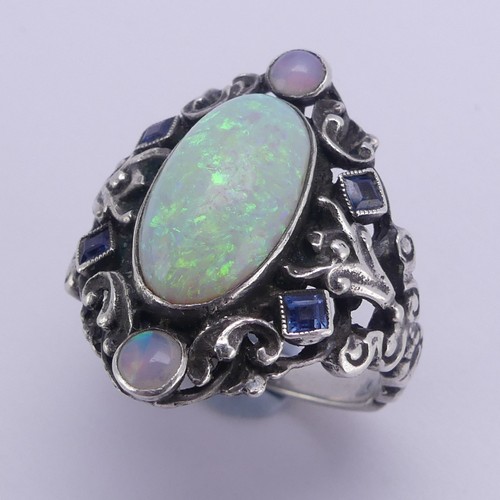 138 - An Arts and Crafts silver Ring, in the manner of Bernard Instone, with central cabochon opal, approx... 