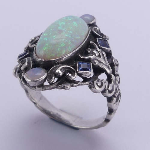 138 - An Arts and Crafts silver Ring, in the manner of Bernard Instone, with central cabochon opal, approx... 