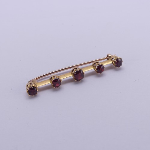 226 - A graduated five stone garnet Bar Brooch, the circular facetted stones claw set, all unmarked, the b... 