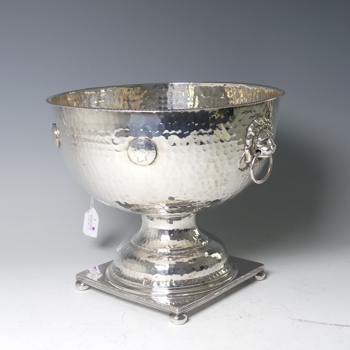 55 - A silver plated Punch Bowl, with hammered decoration and lion mask ring handles, raised on square ba... 