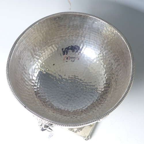 55 - A silver plated Punch Bowl, with hammered decoration and lion mask ring handles, raised on square ba... 