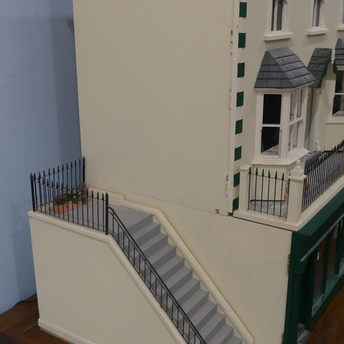 327 - A very large 20th century scratch built hand painted Dolls House, consisting of four floors, ground ... 