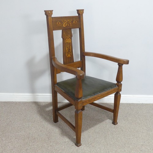 An Arts and Crafts oak Armchair in the manner of Shapland and Petter of Barnstaple, the backrest decorated with stylised floral inlay, above upholstered seat and raised on shaped supports, W 66 cm x H 116 cm x D 57 cm.