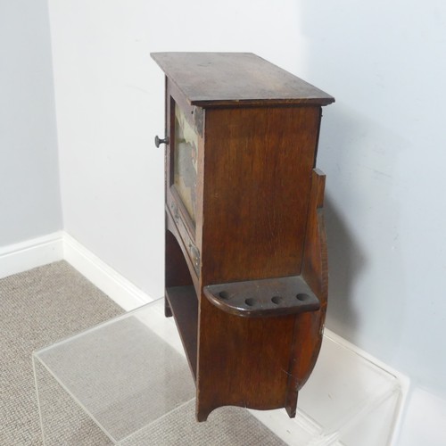 520 - A rare Shapland and Petter of Barnstaple Arts and Crafts oak smokers Cabinet, circa 1900, the cupboa... 