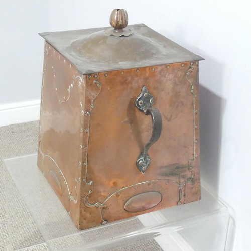 522 - An Arts and Crafts copper coal Box, the top mounted with flower finial above embossed and studded pa... 