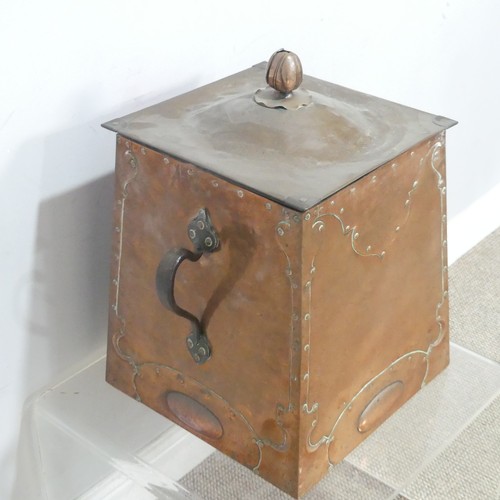 522 - An Arts and Crafts copper coal Box, the top mounted with flower finial above embossed and studded pa... 