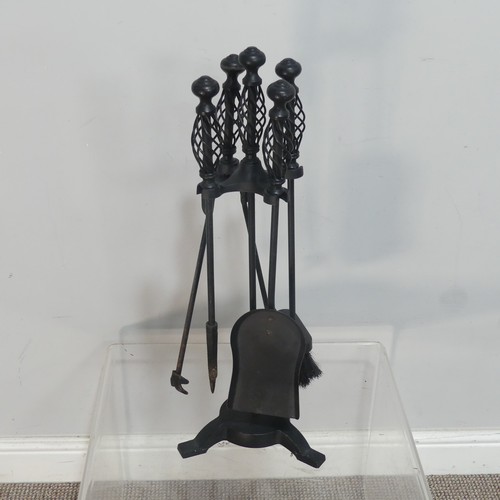 543 - A set of four wrought iron Fire Irons, together with another set of fire irons, a large brass trivet... 