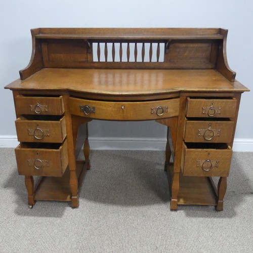 500 - Attributed to Shapland and Petter of Barnstaple, an Arts and Crafts oak Desk, the three quarter gall... 