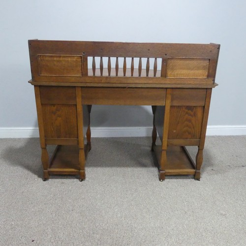 500 - Attributed to Shapland and Petter of Barnstaple, an Arts and Crafts oak Desk, the three quarter gall... 