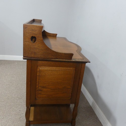 500 - Attributed to Shapland and Petter of Barnstaple, an Arts and Crafts oak Desk, the three quarter gall... 