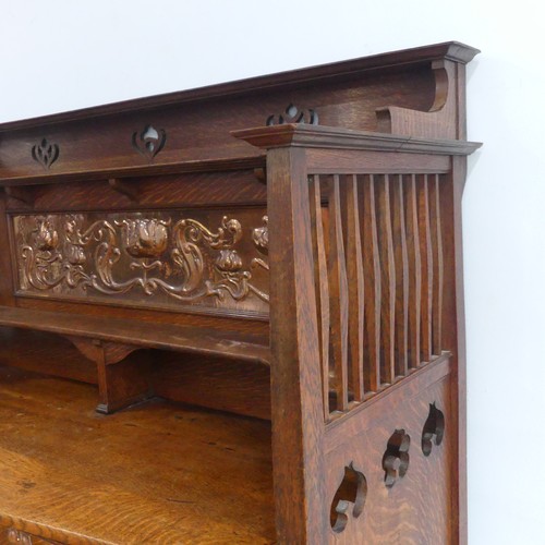 513 - A Shapland and Petter of Barnstaple Arts and Crafts oak Sideboard, the raised top with pierced flora... 