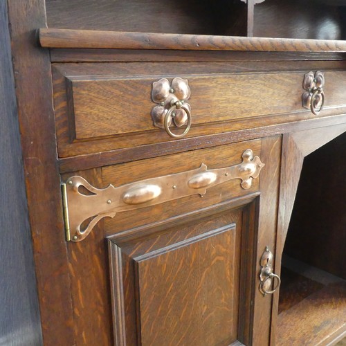 513 - A Shapland and Petter of Barnstaple Arts and Crafts oak Sideboard, the raised top with pierced flora... 